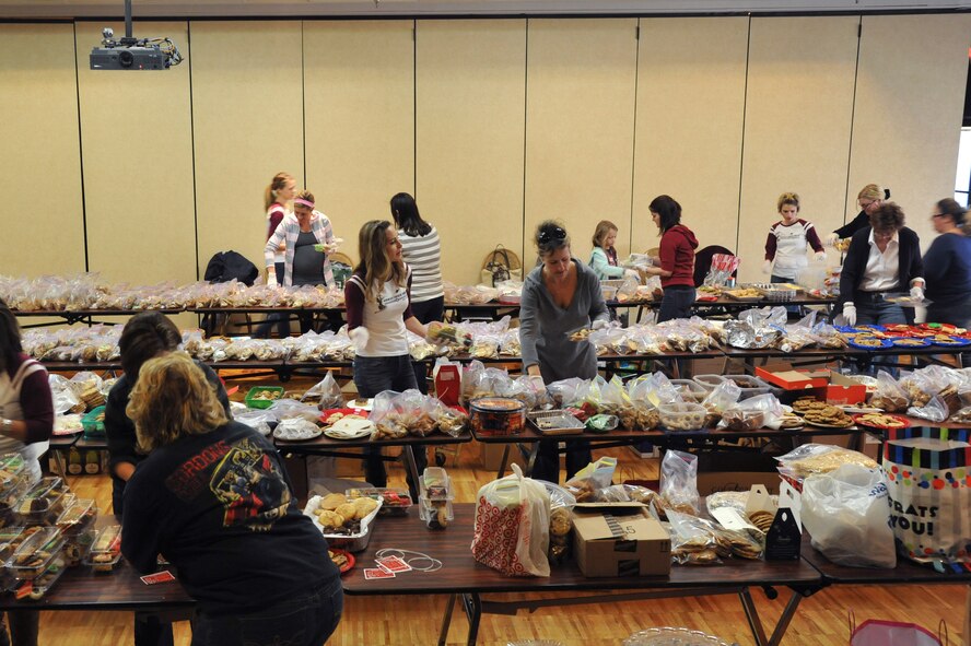 Luke members package up cookies Dec. 10 to be delivered to airmen who live in the dorms during the Airman Cookie Drive held at Club Five Six. (U.S. Air Force photo by Senior Airman Sandra Welch)