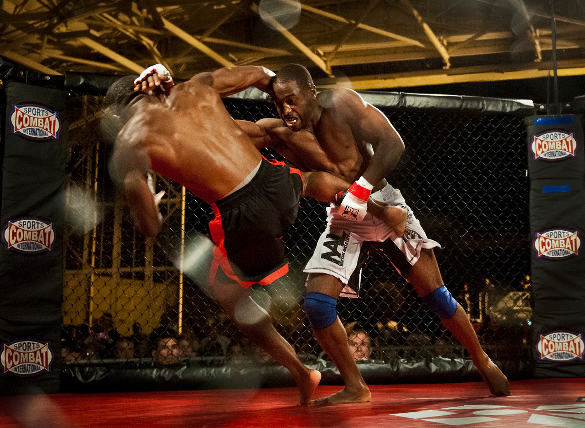 Steve Burks takes down Michael Roberts during their mixed martial arts bout at the Strike Fight event Dec. 8 at Eglin Air Force Base, Fla.  Burks, a staff sergeant with the 1st Special Operations Wing, fought Roberts to a draw in one of 11 matches held at the base’s first-ever MMA event.  The debut event drew approximately 775 people.  (U.S. Air Force photo/Samuel King Jr.)