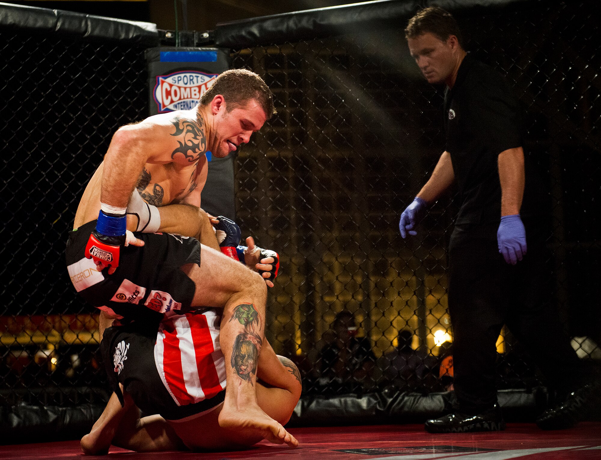 Joe Elmore wrestles with John Harris during their mixed martial arts bout at the Strike Fight event Dec. 08 at Eglin Air Force Base, Fla.  Elmore won a unanimous decision over Harris in one of 11 matches held at the base’s first-ever MMA event that drew approximately 775 people.  (U.S. Air Force photo/Samuel King Jr.)