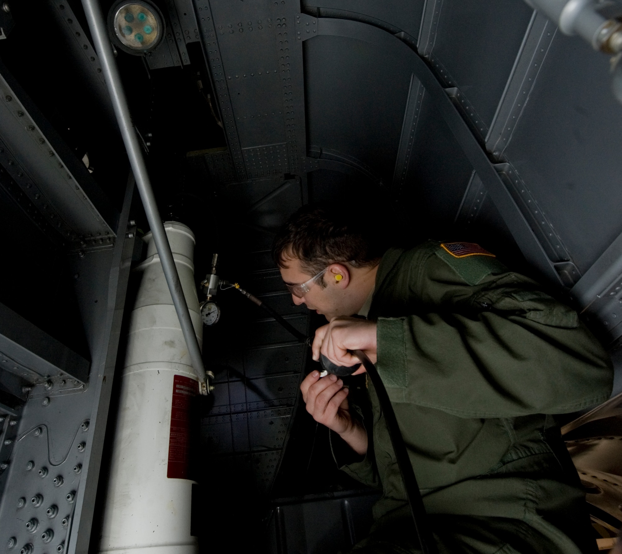 1st Lt. David Field, 39th Airlift Squadron, maintains a shock valve on a C-130J during Impact Day Dec. 7, 2012, at Dyess Air Force Base, Texas. Impact Day gave aircrew the opportunity to see what it takes to generate an aircraft with hands-on experience. The aircrew also learned how to pack a parachute, maintain a C-130J and repair a leak in a fuel cell. (U.S. Air Force photo by Airman 1st Class Jonathan Stefanko/ Released)