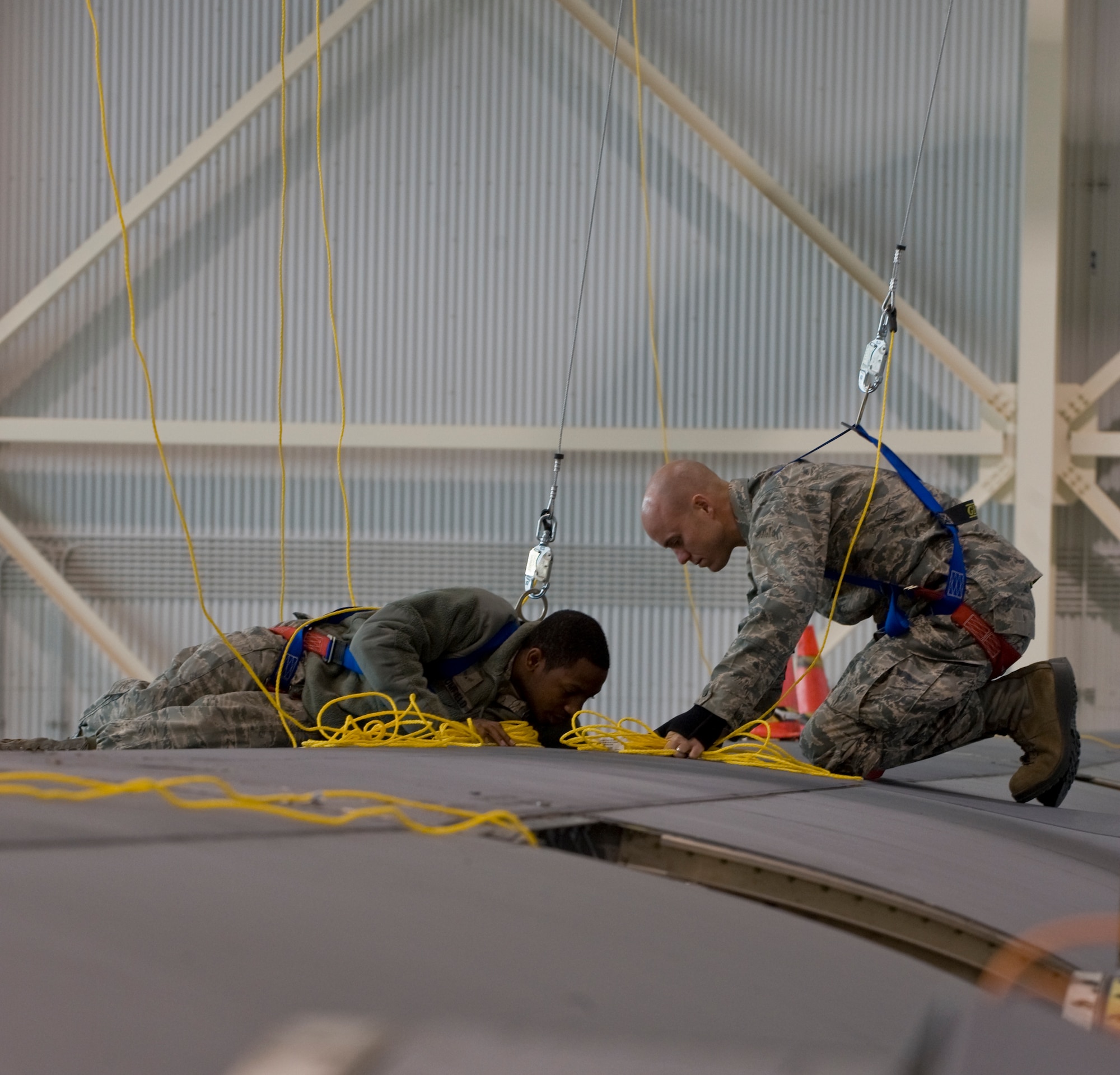 Airman 1st Class Jasani Bromfield, left, 317th Maintenance Squadron, shows Capt. David Marcus, right, 39th Airlift Squadron, a dry dock of a C-130J during Impact Day Dec. 7, 2012, at Dyess Air Force Base, Texas. Impact Day gave aircrew the opportunity to see what it takes to generate an aircraft with hands-on experience. The aircrew also learned how to pack a parachute, maintain a C-130J and repair a leak in a fuel cell. (U.S. Air Force photo by Airman 1st Class Jonathan Stefanko/ Released)