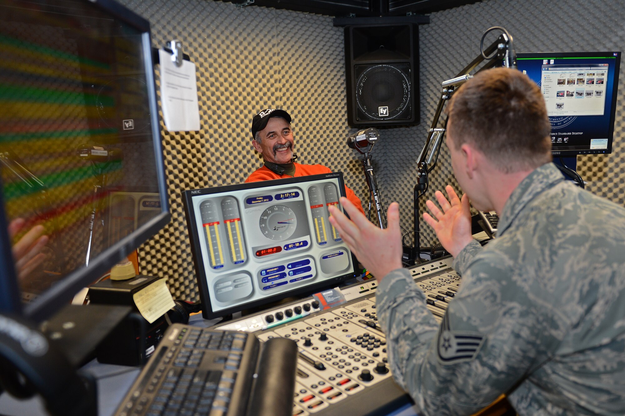 SPANGDAHLEM AIR BASE, Germany – U.S. Air Force Staff Sgt. Richard Kaulfers, American Forces Network Spangdahlem radio disc jockey from Pittsburgh, interviews Aaron Tippin, country music singer, during a live radio show Dec. 7, 2012. The interview helped publicize Tippin’s evening concert at the Skelton Memorial Fitness Center. (U.S. Air Force photo by Airman 1st Class Dillon Davis/Released)