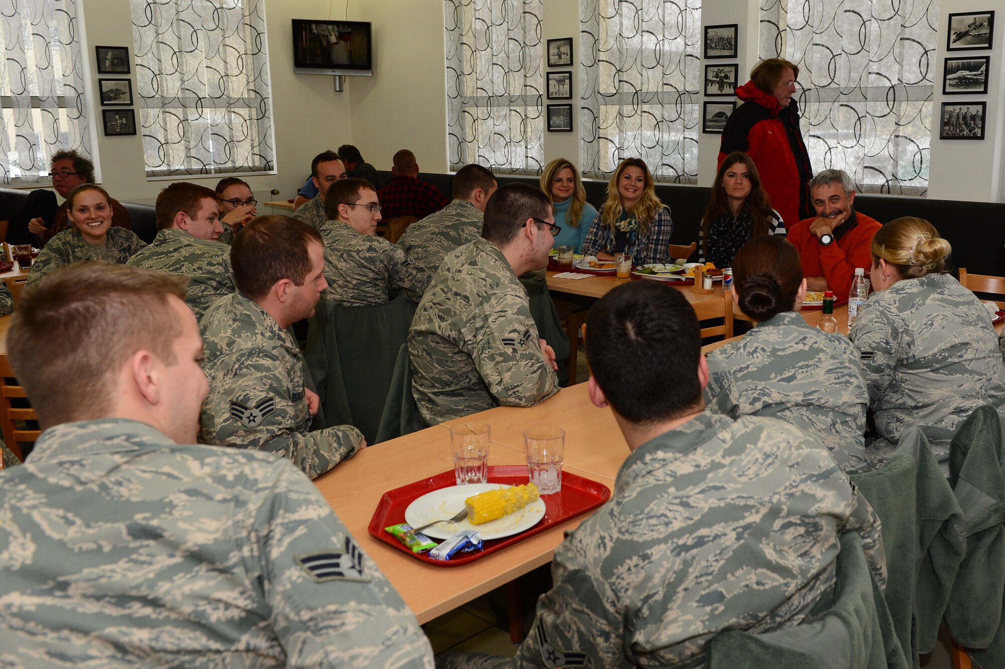 SPANGDAHLEM AIR BASE, Germany – Aaron Tippin, country music singer, and The Lowry Sisters, country music group, eat lunch with Airmen from the 52nd Fighter Wing during their base tour Dec. 7, 2012. The Lowry Sisters are the opening act for Tippin on his Armed Forces Entertainment tour to several bases throughout Europe. (U.S. Air Force photo by Airman 1st Class Dillon Davis/Released)