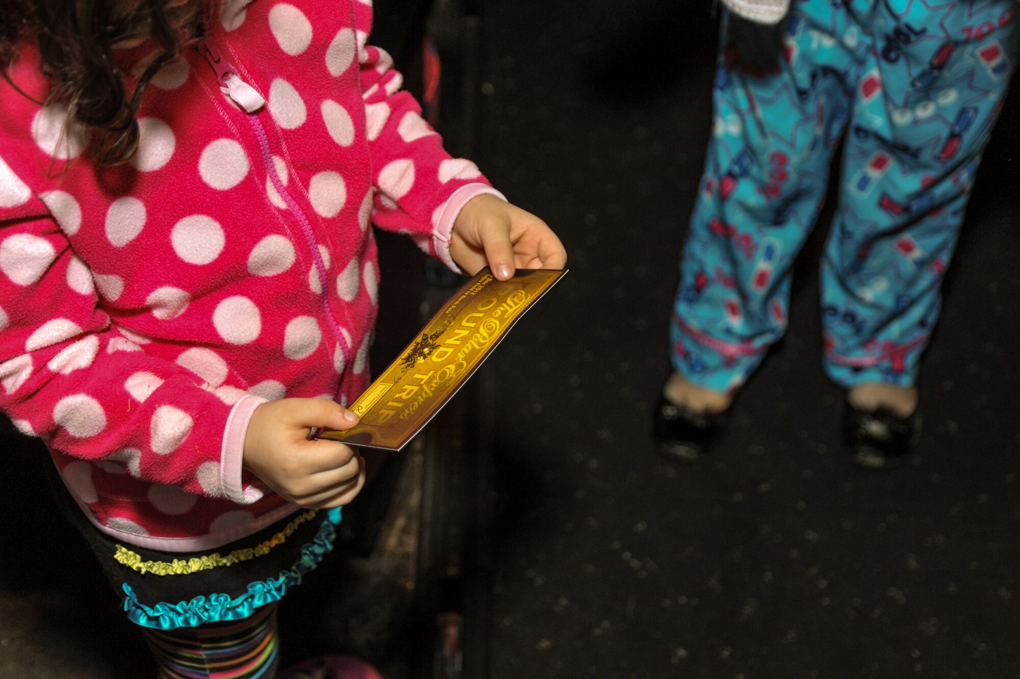 At the conclusion of "The Polar Express" film, children dressed comfortably in pajamas took out their golden roundtrip tickets to board The Polar Express train, simulated by two holiday decorated buses, for an adventure through Winter Wonderland in the Nascer do Sol housing area. Their trip ended with a holiday tree lighting ceremony and a special visit from Santa Claus. This event was the kickoff to a series of December holiday events on Lajes. (U.S. Air Force photo by Staff Sgt. Angelique N. Smythe) 

 