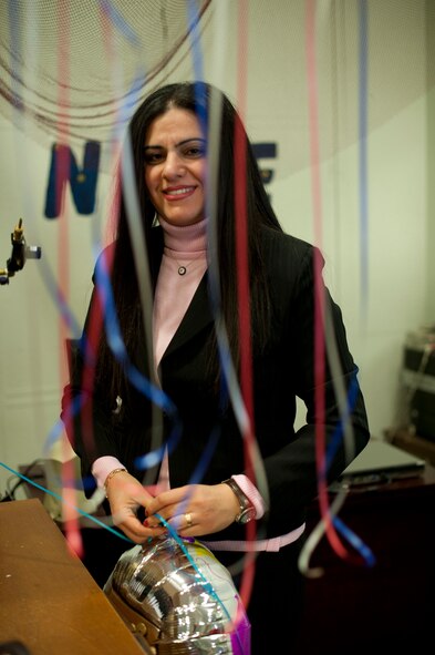 Seckin Atmis, 39th Force Support Squadron programs specialist, puts the final touch on a balloon for a customer Nov. 29, 2012, at Incirlik Air Base, Turkey. Atmis has worked at the community center for eight years and hopes to stay until she retires. (U.S. Air Force photo by Senior Airman Clayton Lenhardt/Released)