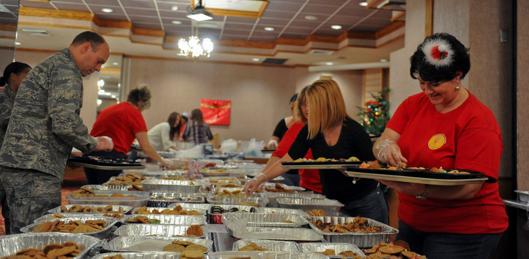 U.S. Air Force Col. Jeff Ullmann, 18th Mission Support Group commander, and volunteers participate in the 2012 cookie drive on Kadena Air Base, Japan, Dec. 11, 2012. About 70 volunteers helped in the collection, unwrapping, separating and the boxing of more than 32,000 cookies, which were converted into more than 2,700 cookie trays for single service members on Okinawa. (U.S. Air Force photo/Airman 1st Class Justin Veazie)