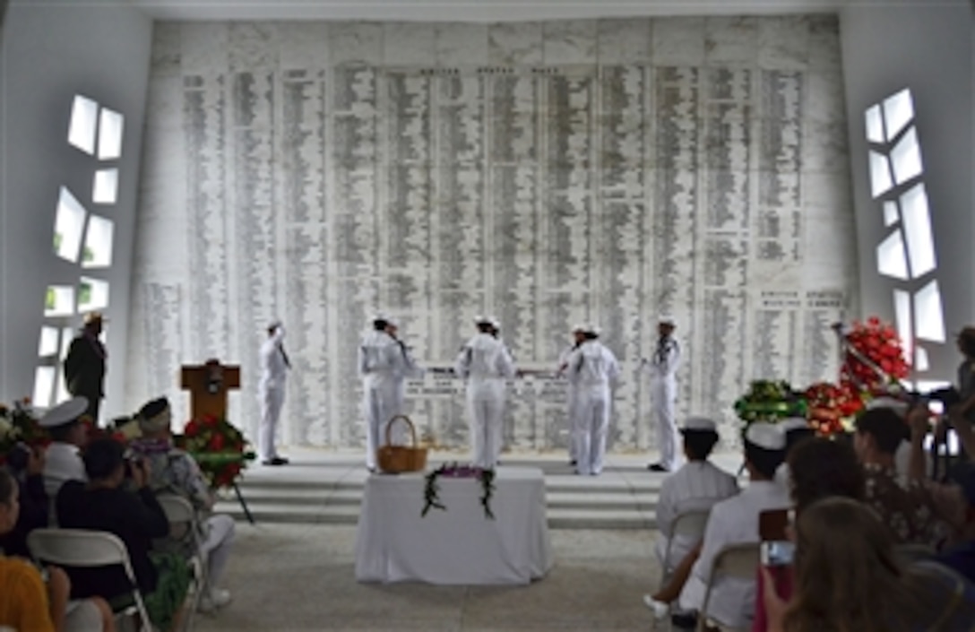 Sailors fold the flag during ceremonies for the interment of Seaman 1st Class Wallace F. Quillin at the USS Arizona Memorial in Pearl Harbor, Hawaii, on Dec. 7, 2012.  Quillin’s remains were placed in the USS Arizona by National Park Service divers.  