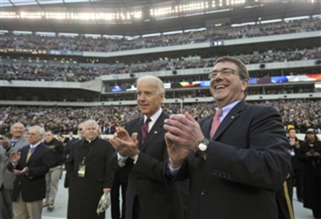 Vice President Joseph Biden, left, and Deputy Secretary of Defense Ashton B. Carter applaud after the National Anthem is played before the start of the Army vs. Navy football game at Lincoln Financial Field in Philadelphia, Pa., on Dec. 8, 2012.  The West Point Black Knights take on the Naval Academy Midshipmen in the 113th meeting between the two service schools.  
