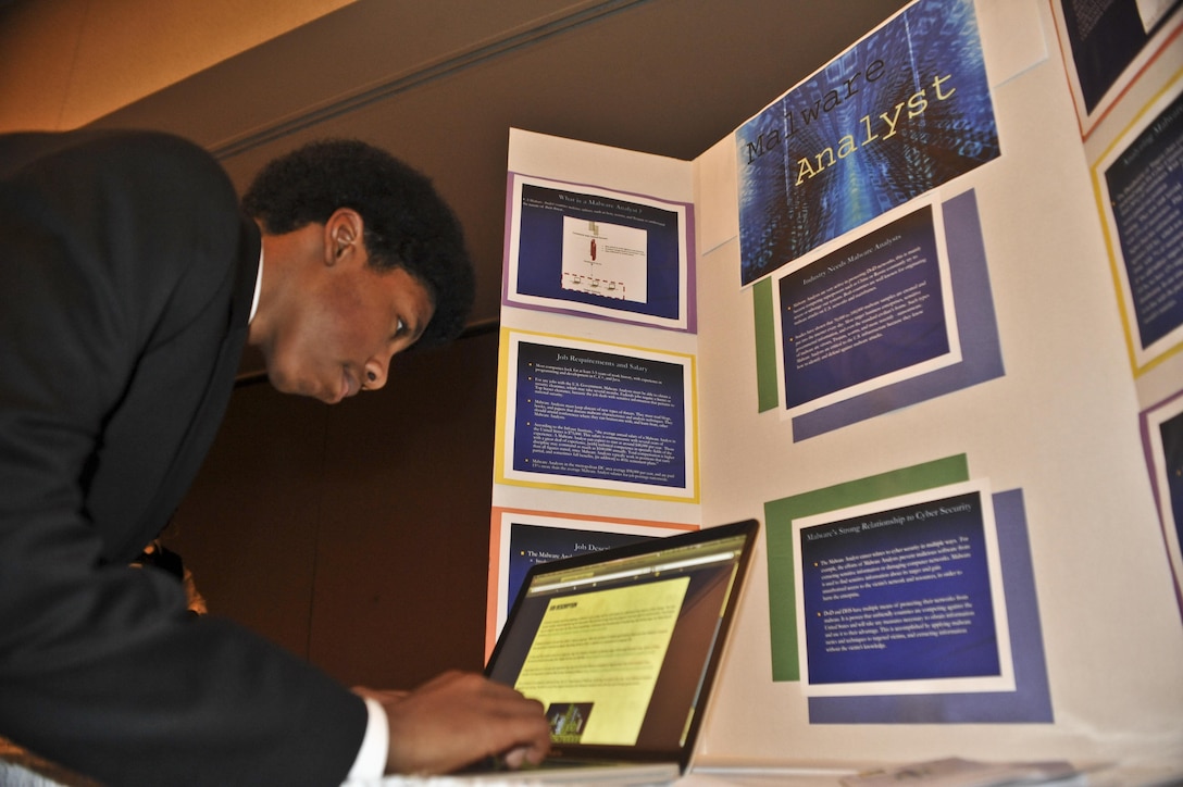 MARINE CORPS BASE QUANTICO, Va. (Dec. 5.) – Darius, eighth grade, finalizes  his team's website during the