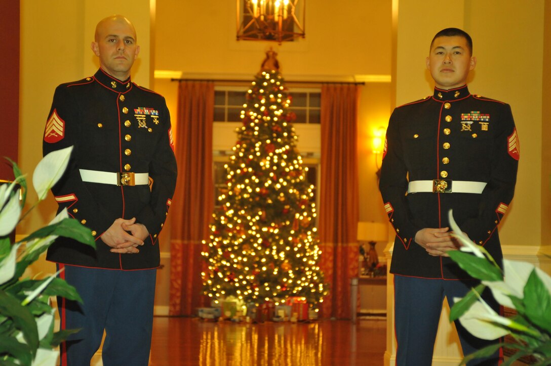 Sgt. David Anderson, medium section head Base Motor Transportation, and Sgt. Christopher Lee, platoon sergeant for Base Motor Transportation, stand at the front door ready to greet the families attending the Exceptional Family Member Program’s Holiday Event at the Lincoln Military Housing Family Center Party Room on Friday. Children had a good time at the event, especially when Santa Claus stopped by for a visit. (U.S. Marine Corps photo by Lance Cpl. Antwaun L. Jefferson/Released)
