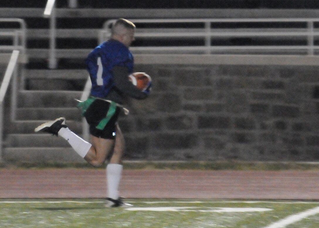 Zack Doty, head coach for Marine Helicopter Squadron-1 American League intramural flag football team, runs unopposed for the final touchdown of the game against Headquarters and Service Battalion during the first round of the playoffs at Butler Stadium on Dec. 3. HMX-1 defeated H$SBn., 18 – 0.
