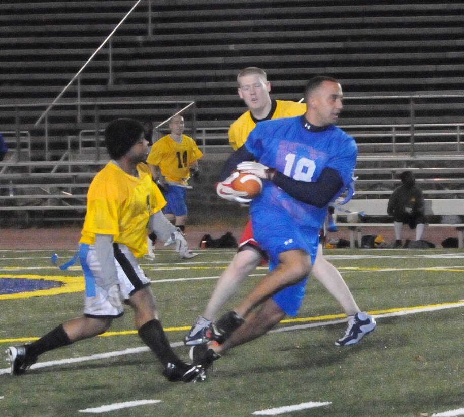Michael Diaz, a player for Marine Helicopter Squadron-1’s American League intramural flag football team, rushes toward the end zone during the first round of the playoffs at Butler Stadium on Dec. 3. HMX-1 defeated H&SBn., 18 – 0.