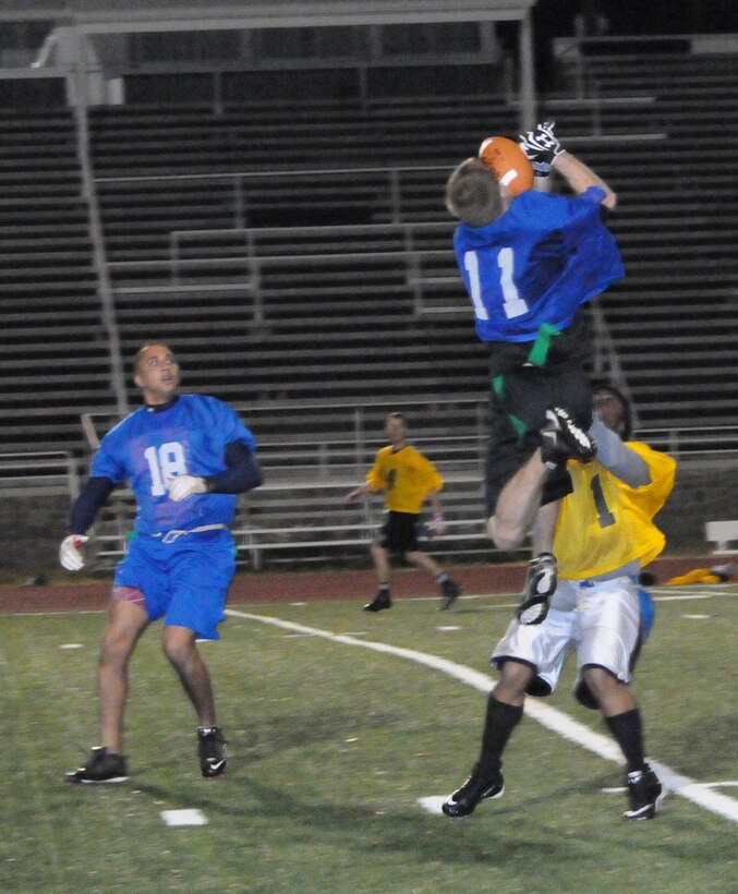 Dustin Dunn, a player for Marine Helicopter Squadron-1’s American League intramural flag football team, leaps to catch the ball during the first round of the playoffs at Butler Stadium on Dec. 3. HMX-1 defeated H&SBn., 18 – 0.