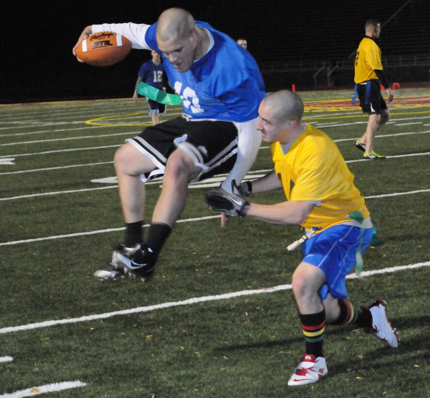 Jarrett Hawkins, a player for Marine Helicopter Squadron-1’s American League intramural flag football team, leaps to evade an opposing player during the first round of the playoffs at Butler Stadium on Dec. 3. HMX-1 defeated H&SBn., 18 – 0.