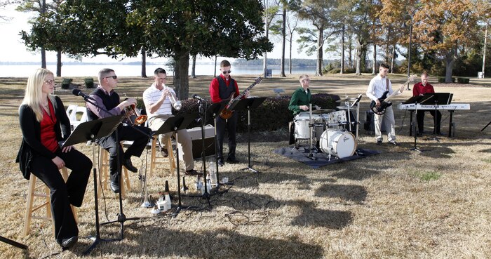 Members of the II Marine Aircraft Wing Band play live music for patrons at the Joint Holiday Reception aboard Marine Corps Base Camp Lejeune Dec. 1. The reception is hosted to give thanks for the combined cooperation of military personnel aboard the base and civilian personnel in the surrounding communities.