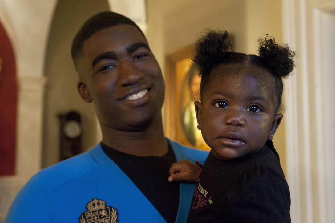 Lance Cpl. Tirone Baldwin, a Marine Barracks Washington, D.C., Marine, posts for a photo inside the Home of the Commandants during an open house event at the Barracks Dec. 9. Marines and their families spent an afternoon visiting the homes of the top leaders of the Marine Corps. Food and beverages, to include sugary treats, were served by the hosts during the event in celebration of the holidays. 
