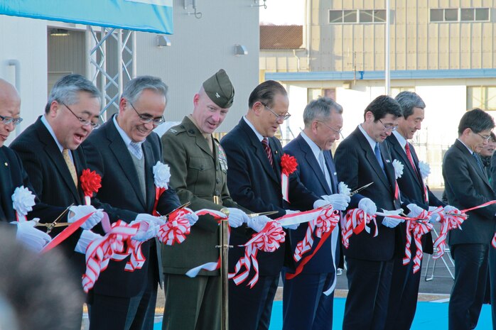 Col. James C. Stewart, Marine Corps Air Station Iwakuni commanding officer, stands next to distinguished guests at the tape cutting ceremony for the Iwakuni Kintaikyo Airport Dec 9, 2012. Distinguished guests cut the tape and 1,000 civilians invited by the city of Iwakuni were given a pair of scissors to cut ribbon symbolizing the airport as a community asset.