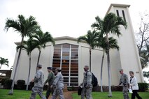 Lt. Gen. Stephen Mueller, Air Force Inspector General, walks in front of the Nelles Chapel Dec. 12 on his way to speak with 15th Wing Sexual Assault Response Victim Advocates at Joint Base Pearl Harbor-Hickam, Hawaii. The Inspector General provides inspection policy and oversees the inspection and evaluation system for all Air Force nuclear and conventional forces as well as Air Force counterintelligence operations. The Air Force Sexual Assault Prevention and Response Program office is progressively influencing the way the military responds to sexual assault and rape by changing the perceptions of Soldiers, Sailors, Airmen, Marines and Coast Guardsmen. (U.S. Air Force photo by Staff Sgt. Nathan Allen)