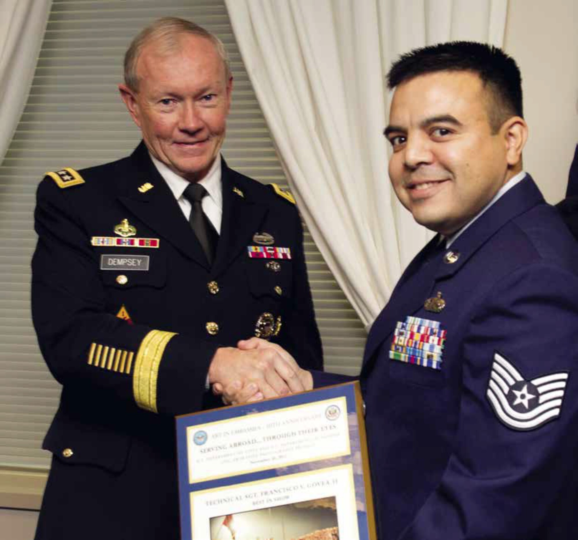U.S. Air Force Tech. Sgt. Francisco V. Govea II, receives an award for one of the 12
“Best in Show” for the State Department’s photography contest, “Serving Abroad...
Through Their Eyes” at the Pentagon from Chairman, Joint Chiefs of Staff, Martin
Dempsey, Nov. 30. Govea’s photo competed against more than 3,200 photos submitted by active or former members of the U.S. military, Foreign Service and Civil Service employees. (Department of Defense photo by Erin Kirk-Cuomo)