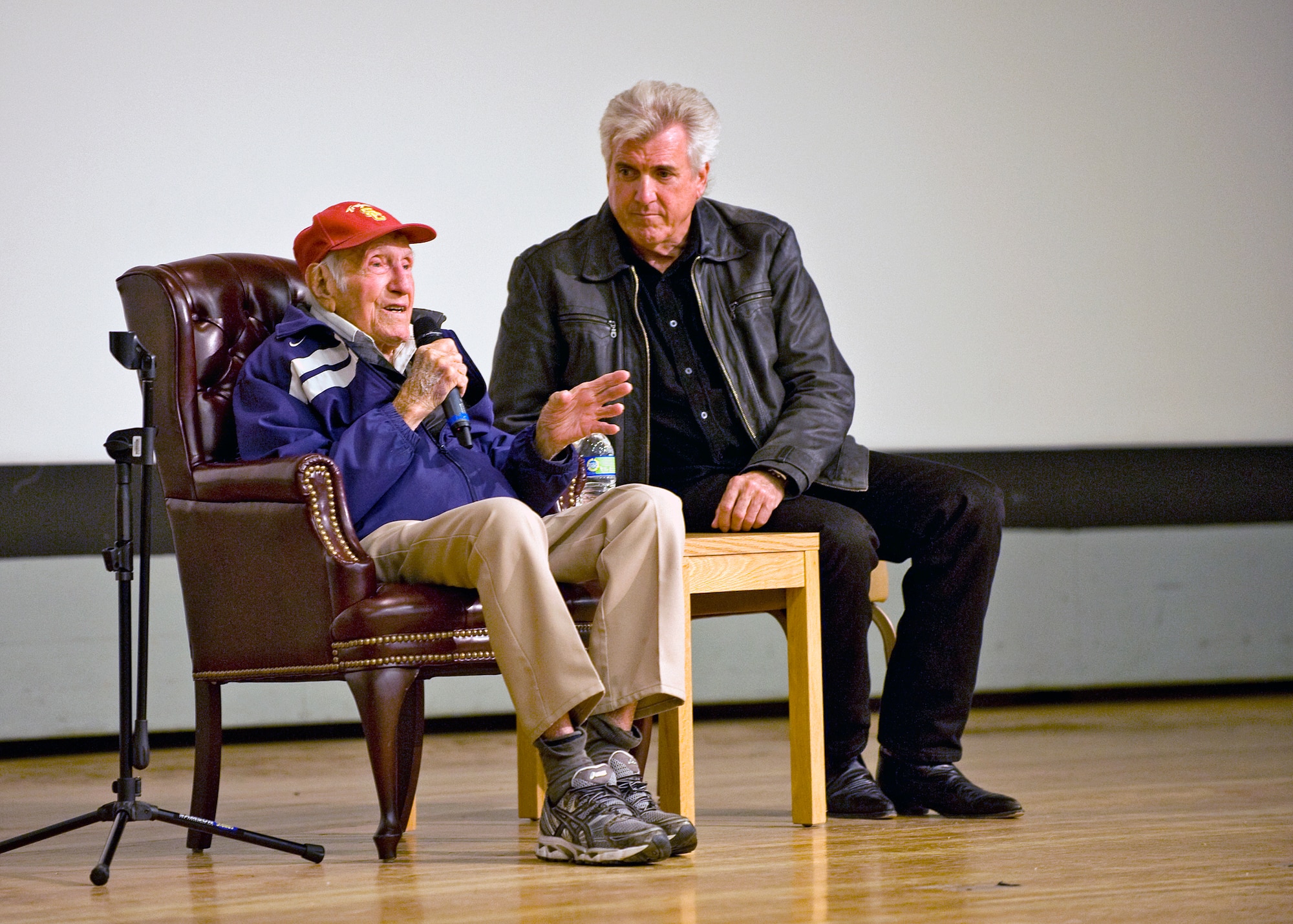 Louis Zamperini (left) with his son, Luke, answer questions during resilience training during the Wingman Day event held at the Base Theater Dec. 10, 2012. (U.S. Air Force photo by Edward Cannon)