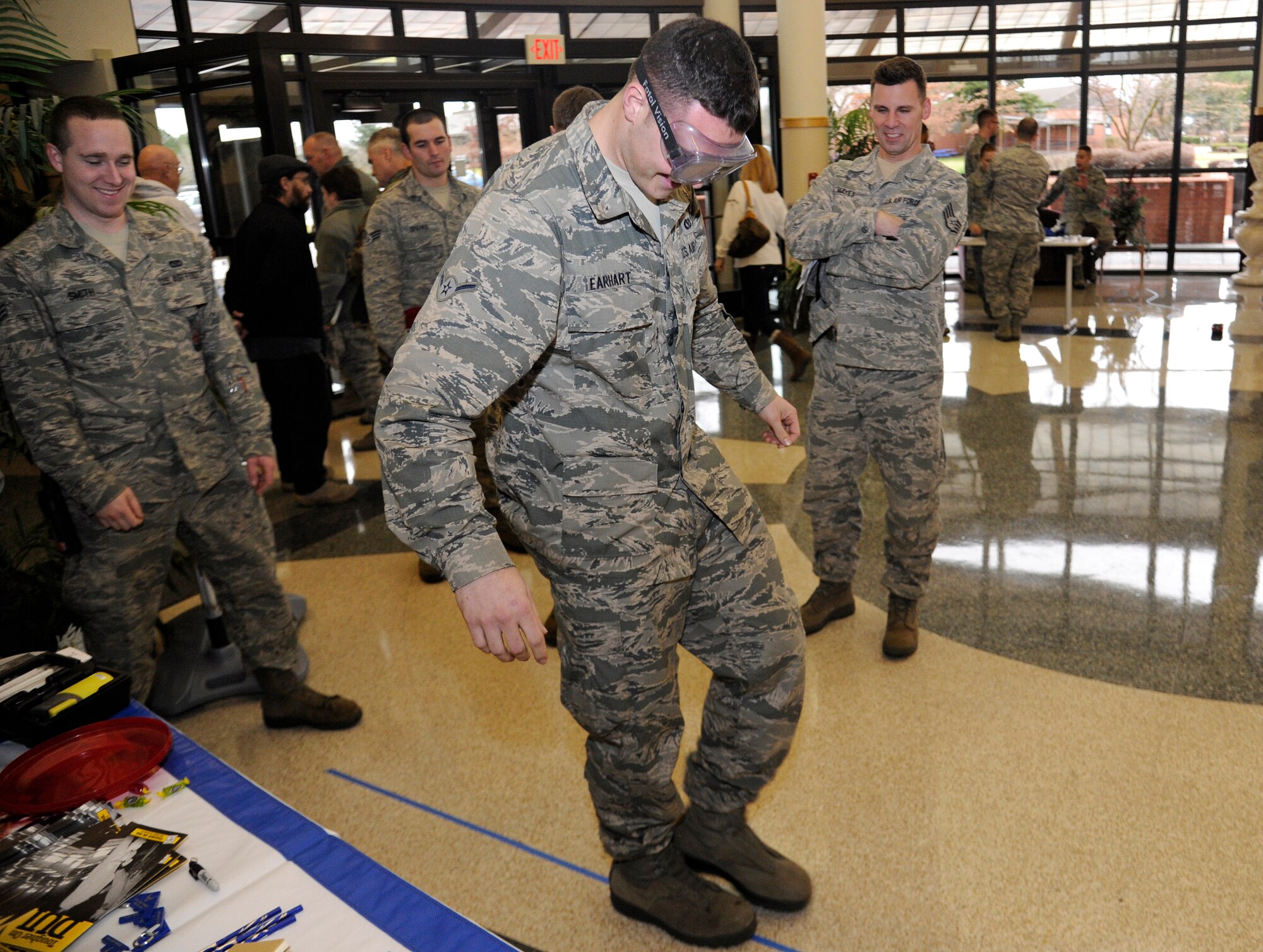 Airman Joshua Earhart, 92nd Civil Engineer Squadron, attempts to walk a straight line with the “drunk goggles” on in the education center at Fairchild Air Force Base, Wash., Dec. 4, 2012. The “drunk goggles” simulate being under the influence of alcohol.(U.S. Air Force photo by Airman 1st Class Ryan Zeski)