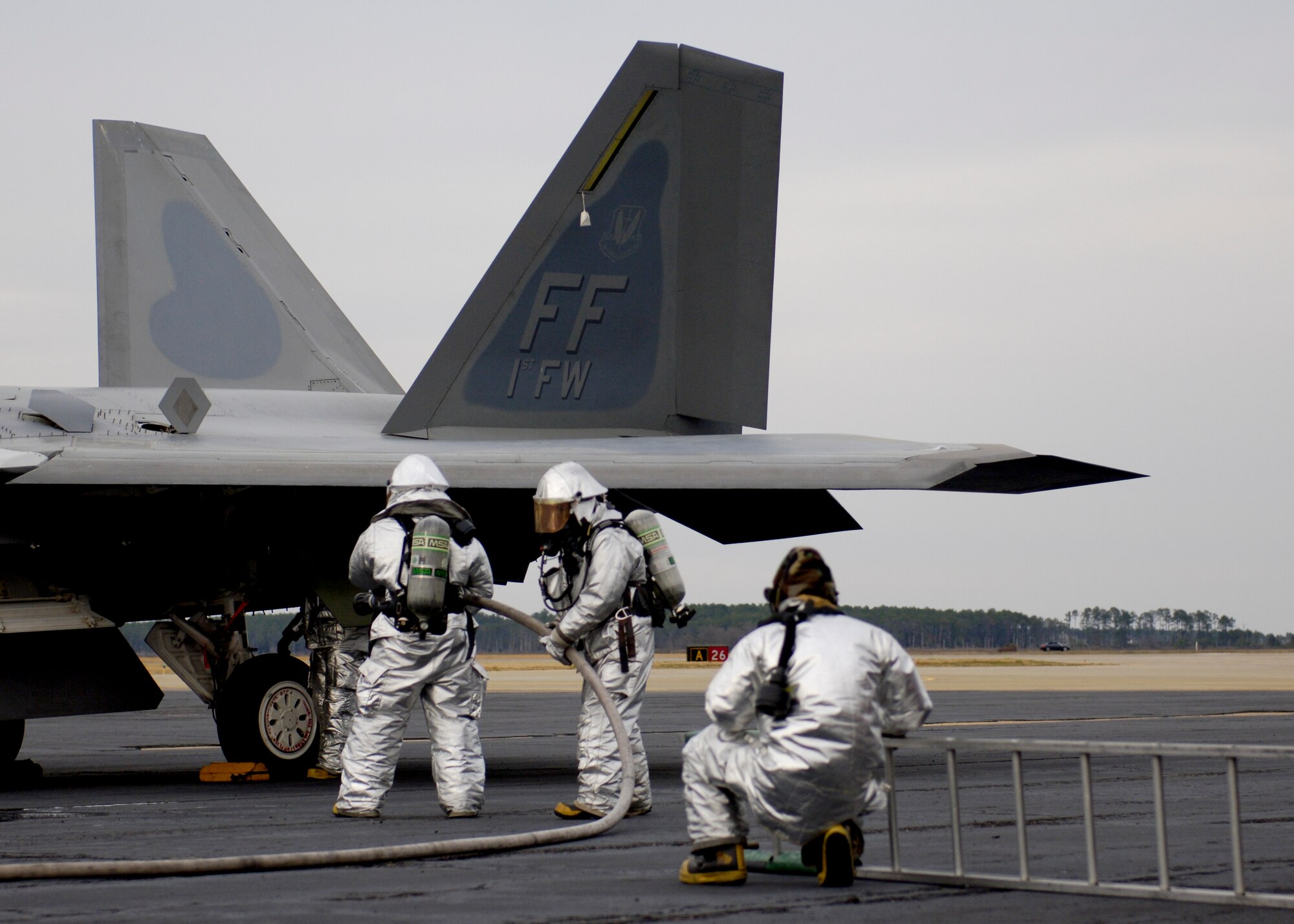 Airmen from the 633rd Civil Engineering Squadron prepare their gear for a simulated extraction of an F-22 Pilot at Langley Air Force Base, Va., Dec. 12, 2012. The Airmen responded to the alert as part of the phase I combined unit exercise. (U.S Air Force photo by Airman Kimberly Nagle/Released)

