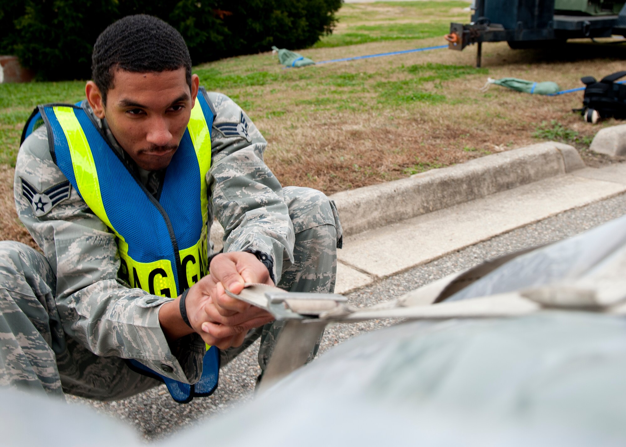 U.S. Air Force Senior Airman Terrence Eaton, 633rd Logistic Readiness Squadron, tightens the strap on a pallet, during the phase I combined unit exercise, at the passenger terminal on Langley Air Force Base, Va., Dec. 11, 2012. Wing Exercise Evaluation Team members assessed the ability of the 633rd Air Base Wing, 1st Fighter Wing and 192nd Fighter Wing to deploy. (U.S. Air Force photo by Staff Sgt. John D. Strong II/Released)