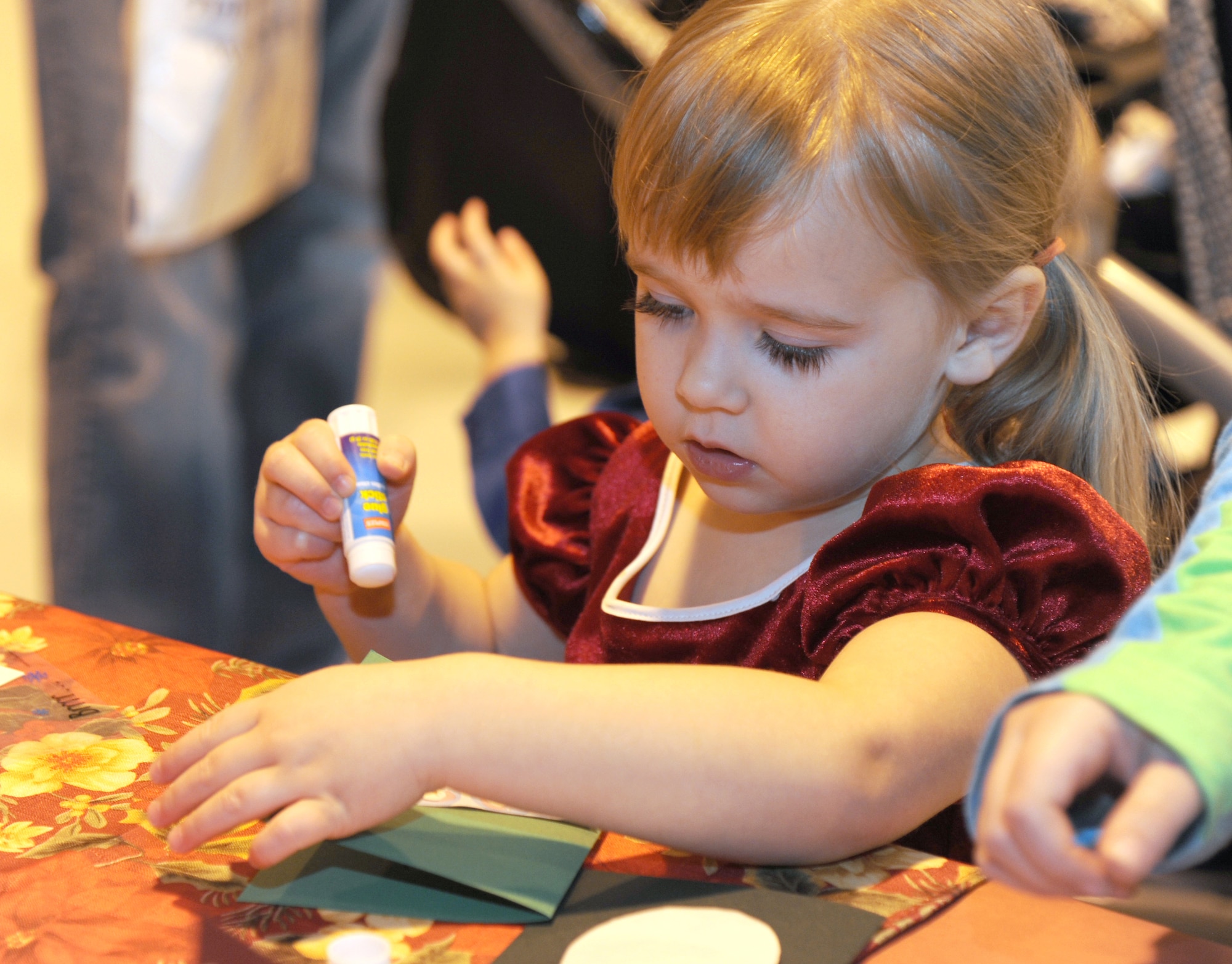 Lilly Schutte, daughter of Capt. Patrick Schutte, an instructor pilot with the 8th Flying Training Squadron, works on a Christmas card for Santa Claus during the Breakfast with Santa event held Dec. 1 in Hangar 170 at Vance Air Force Base, Okla. (U.S. Air Force photo/ Airman 1st Class Frank Casciotta)