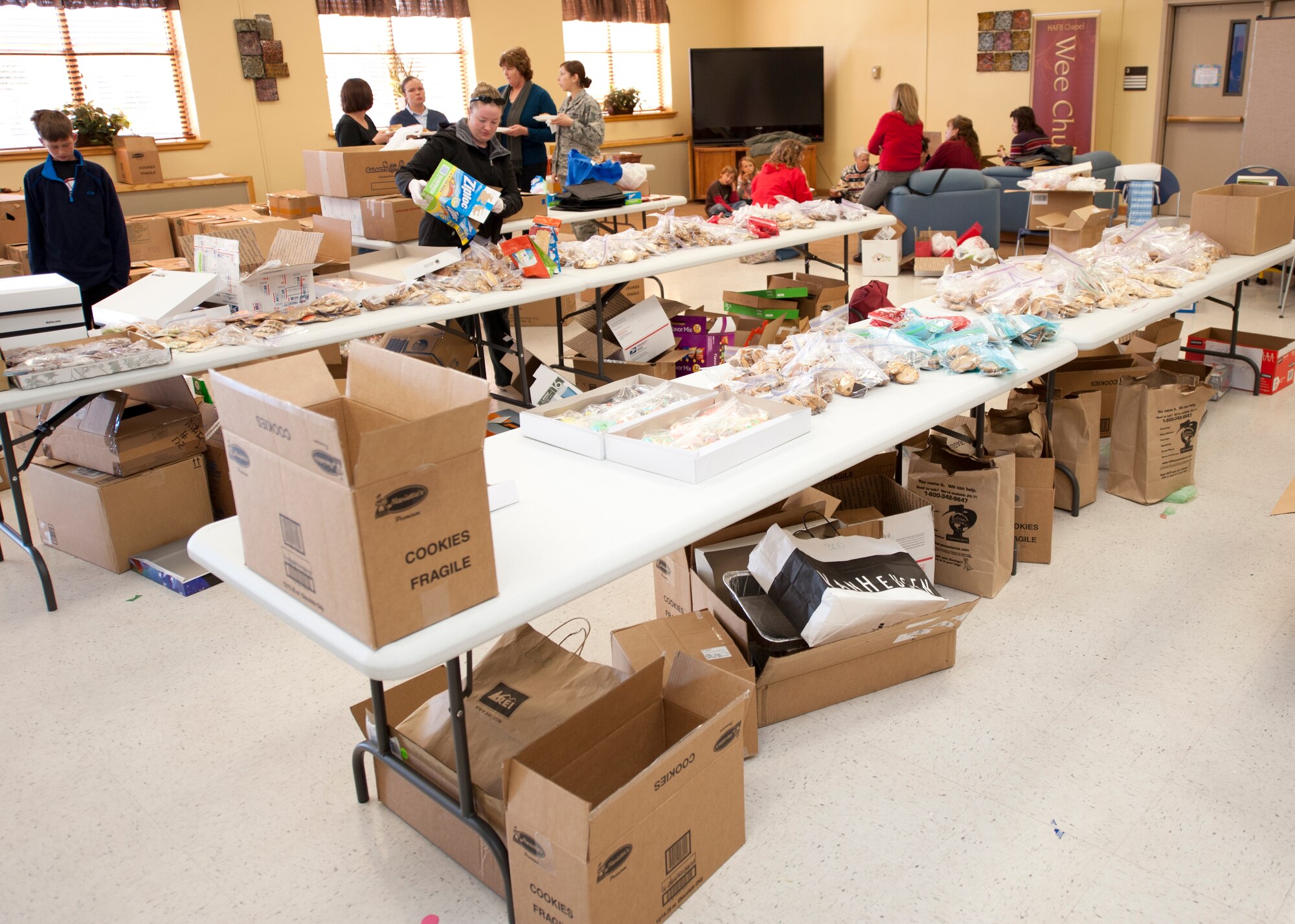 Members of the Holloman Air Force Base, N.M., officers and enlisted spouses’ clubs package cookies as part of the annual holiday cookie drive at the base chapel, Dec. 10. The cookie drive provides cookies to Airmen in the dorms and visiting Airmen to provide a “taste of home” during the holiday season. More than 2,600 dozen cookies were collected – 1,000 dozen more than the drive's goal of 1,600 dozen. (U.S. Air Force photo by Airman 1st Class Colin Cates/Released) 