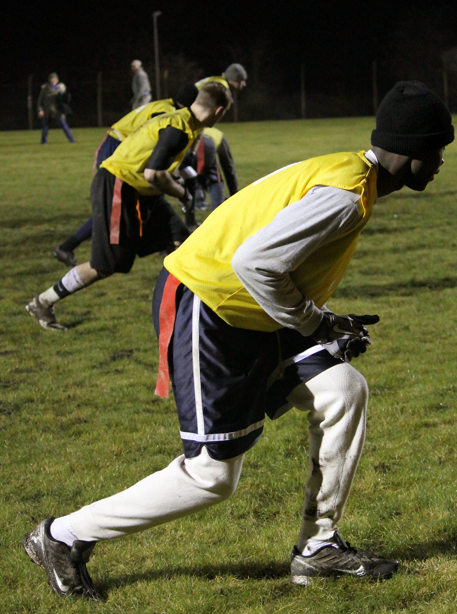 The 100th Maintenance Group team lines up to run a play during the RAF Mildenhall flag football championship game Dec. 12, 2012, at RAF Mildenhall, England. Maintenance defeated the 100th Communications Squadron/Force Support Squadron team by a final score of 14-12. (U.S. Air Force photo by Capt. Jason Smith/Released)