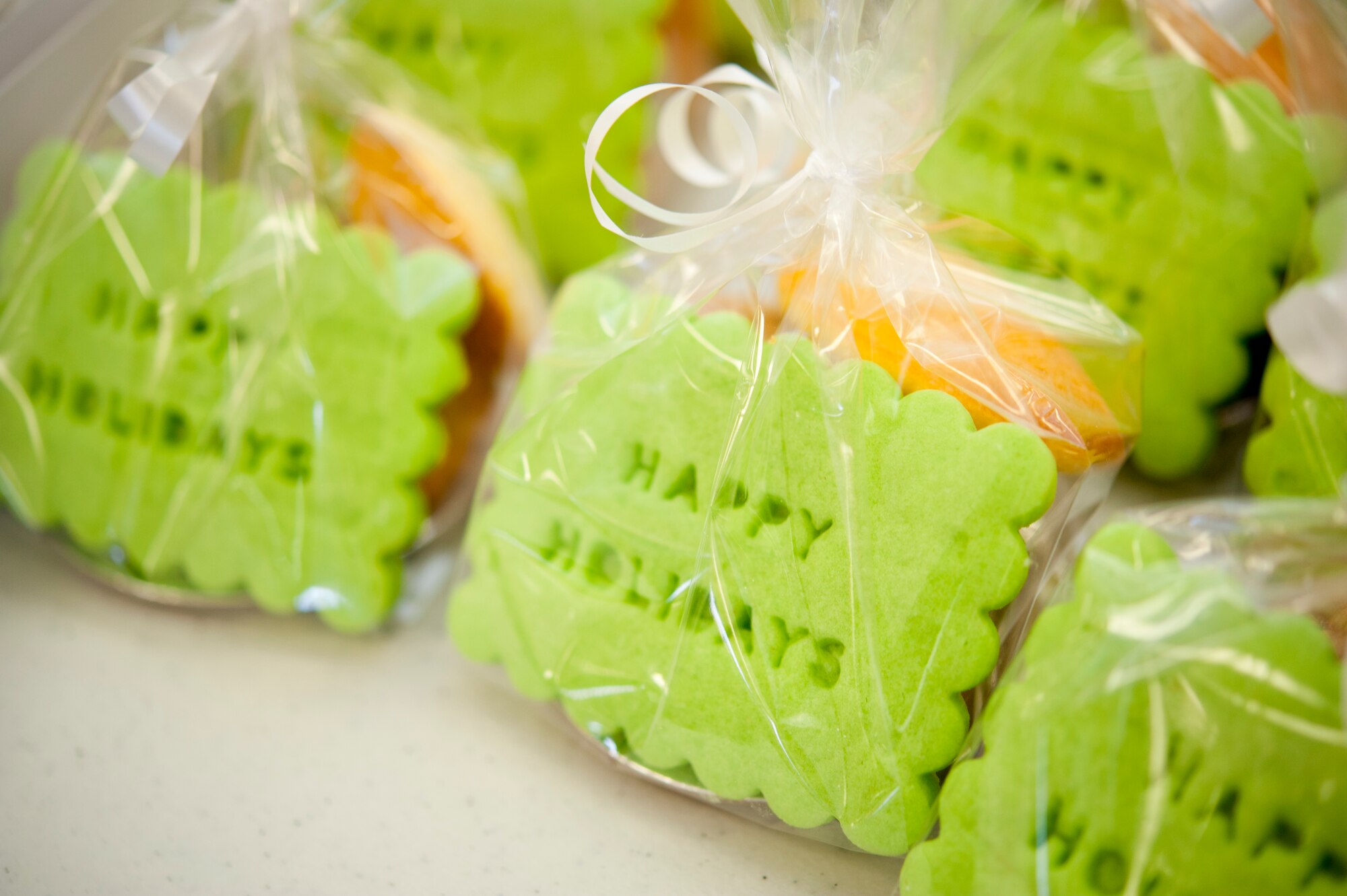 The Holloman Air Force Base, N.M., officers and enlisted spouses clubs display cookies before being packaged at the base chapel Dec. 10 as part of the annual holiday cookie drive. The cookie drive provides cookies to Airmen in the dorms and visiting Airmen to provide a “taste of home” during the holiday season. The cookie packages had a ribbon tied around them with a holiday card made by elementary and middle school students from the community. (U.S. Air Force photo by Airman 1st Class Colin Cates/Released) 