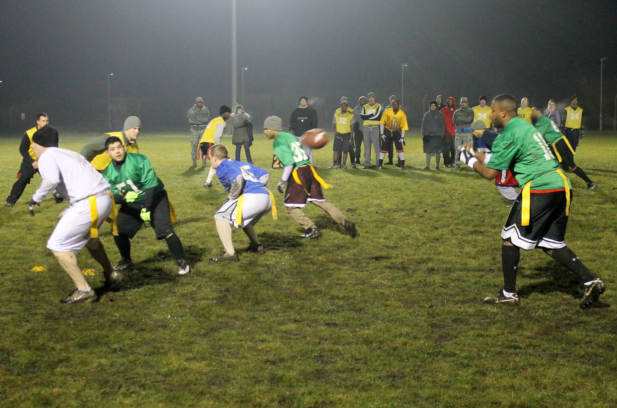 Airman 1st Class Travis Vernon, 100th Communications Squadron/Force Support Squadron team quarterback, takes a snap during the RAF Mildenhall flag football championship game Dec. 12, 2012, at RAF Mildenhall, England. The 100th Maintenance Group team defeated Communications/Force Support by a final score of 14-12. (U.S. Air Force photo by Capt. Jason Smith/Released)