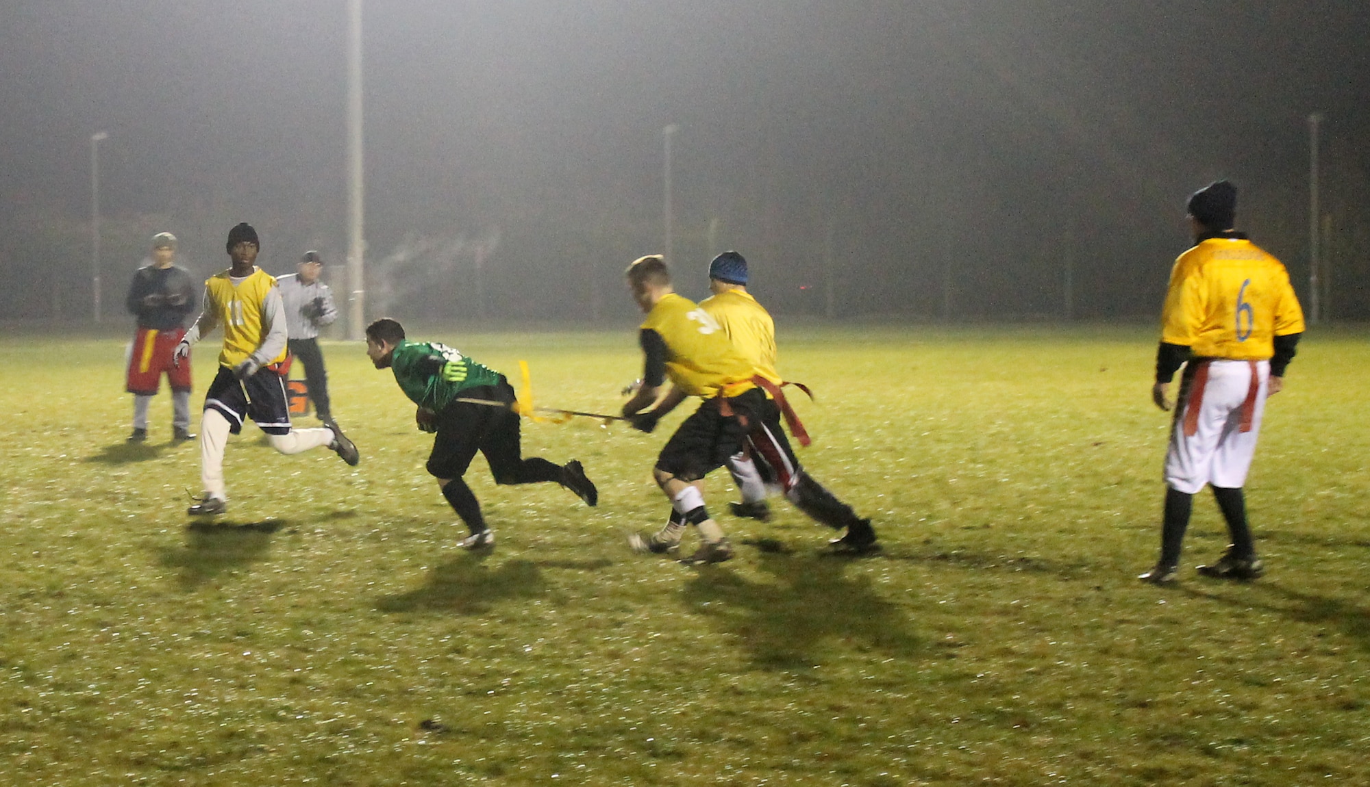 A 100th Maintenance Group team player makes a tackle on a 100th Communications Squadron/Force Support Squadron team player during the RAF Mildenhall flag football championship game Dec. 12, 2012, at RAF Mildenhall, England. Maintenance defeated Communications/Force Support by a final score of 14-12. (U.S. Air Force photo by Capt. Jason Smith/Released)