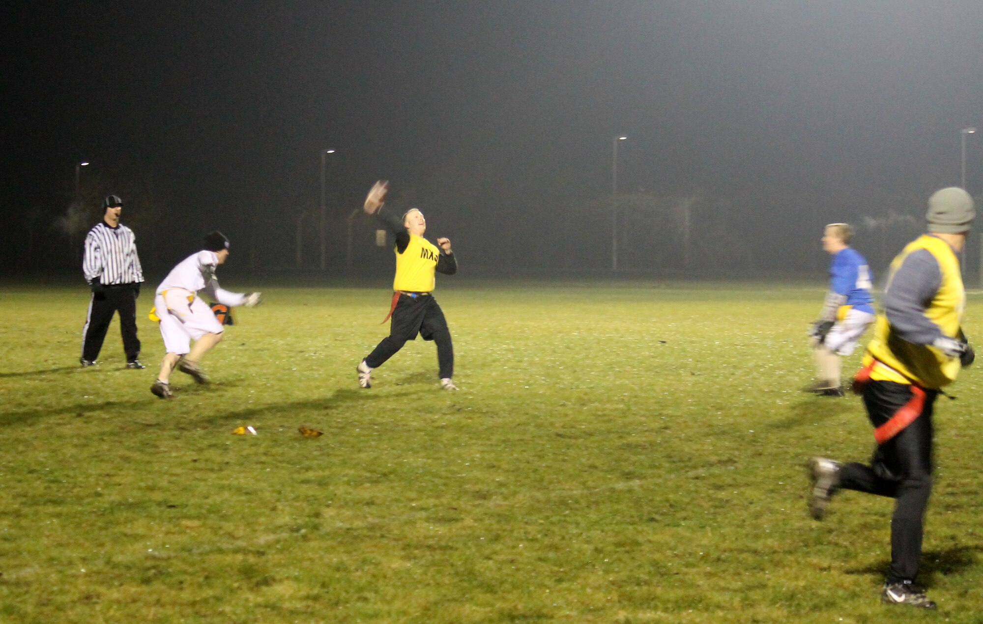 Staff Sgt. Brian Szarek, 100th Maintenance Group team quarterback, throws deep during the RAF Mildenhall flag football championship game Dec. 12, 2012, at RAF Mildenhall, England. Maintenance defeated the 100th Communications Squadron/Force Support Squadron team by a final score of 14-12. (U.S. Air Force photo by Capt. Jason Smith/Released)