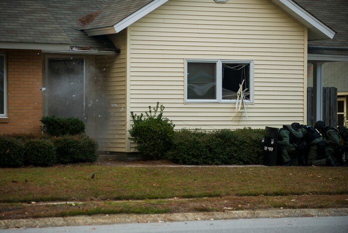 Members of the Charleston County Sheriff’s Office Special Weapons and Tactics team detonate a door charge before raiding a house Dec. 6, 2012, at Joint Base Charleston - Air Base, S.C during a training exercise. The SWAT team provides a coordinated response to critical incidents throughout Charleston County, and whenever requested, in other areas throughout the state of South Carolina.  (U.S. Air Force photo/ Airman 1st Class George Goslin)