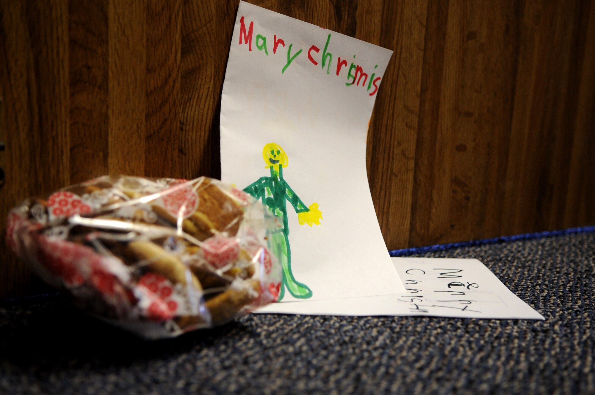 The Grand Forks Air Force Base First Sergeants’ Council sets down a bag of cookies and a few homemade holiday cards at the doorway of an Airman’s dorm room at Cavalier Air Station, N.D., Dec. 10, 2012. Every year, the Grand Forks Air Force Base Spouses’ Club shows their appreciation to Airmen on base by baking cookies and assembling cookie bags to surprise Airmen who live in the dorms.  This year, the First Sergeants’ Council delivered cookies to Airmen stationed on Cavalier Air Station and Grand Forks Air AFB, N.D. (U.S. Air Force photo/Staff Sgt. Amanda N. Grabiec)