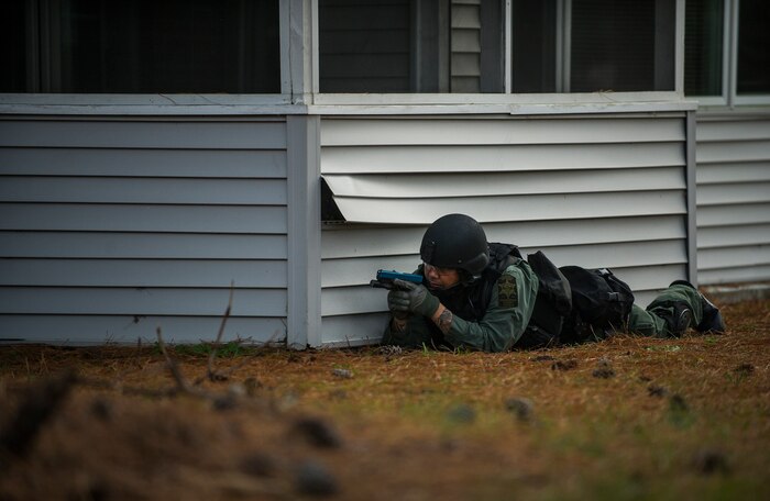 A member of the Charleston County Sheriff’s Office Special Weapons and Tactics team holds a position during a hostage extraction training exercise Dec. 6, 2012, at Joint Base Charleston - Air Base, S.C. The SWAT team coordinated with JB Charleston to utilize old, vacant housing to train using realistic scenarios. (U.S. Air Force photo/ Airman 1st Class George Goslin)