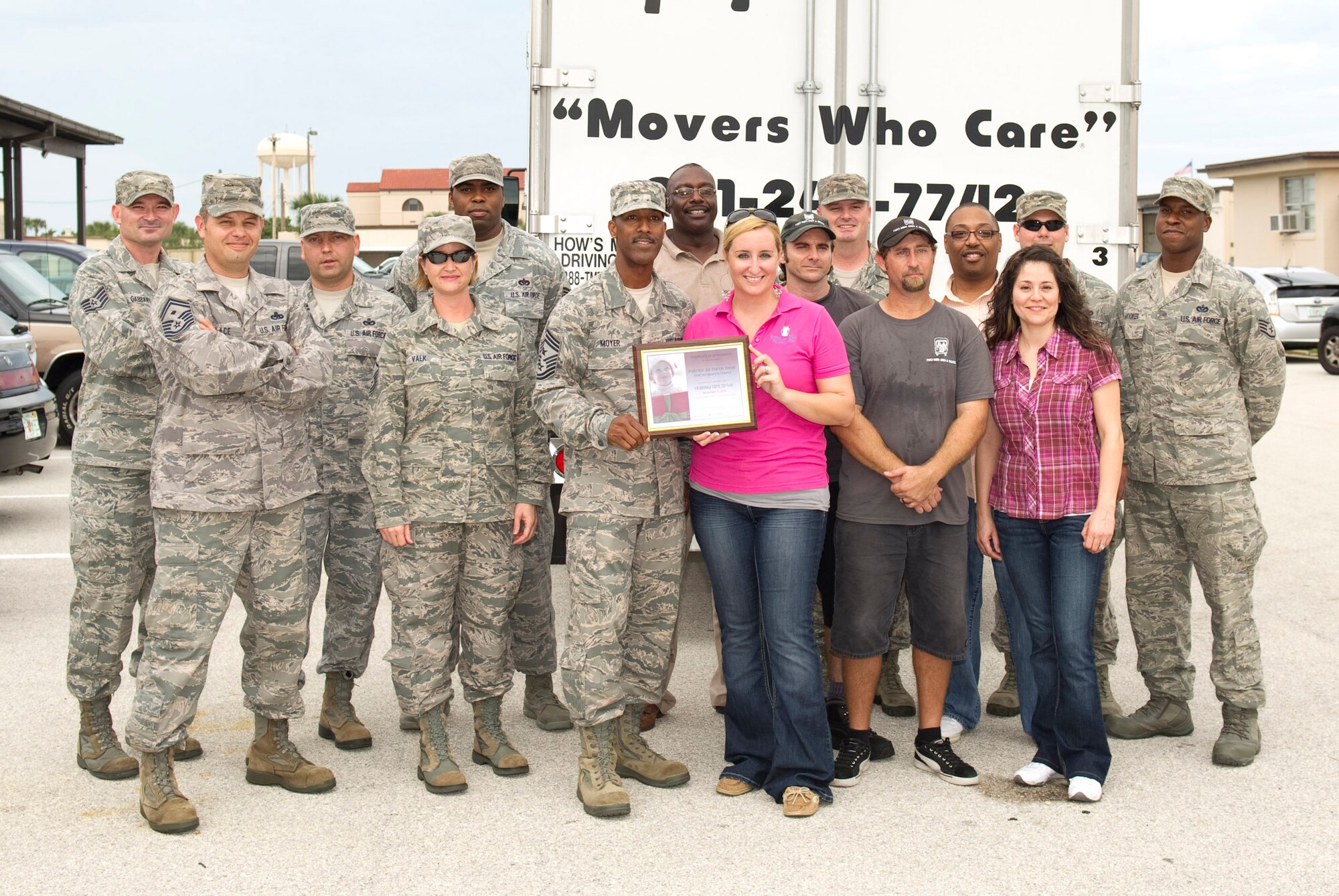 Chief Master Sgt. Herman Moyer, command chief, 45th Space Wing, and members
of the Patrick Air Force Base First Sergeant's Council are given a
certificate of appreciation from Brevard Family Partnership representatives at the Prime Base Engineer Emergency Force building Dec. 10.
