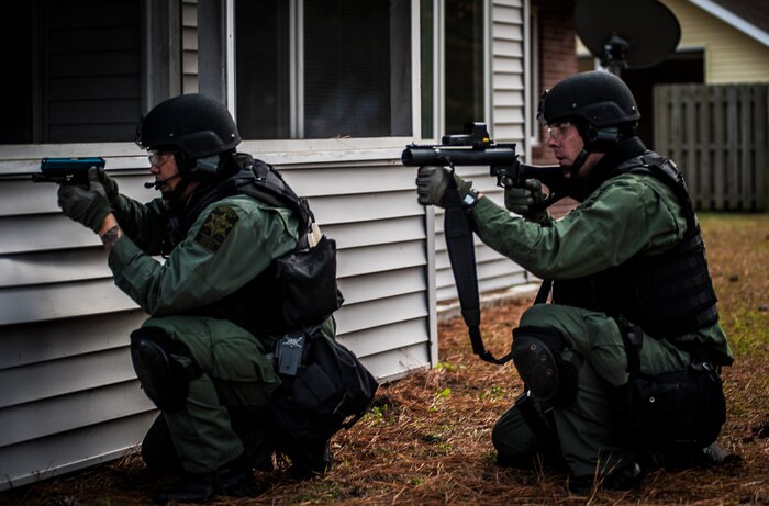 Charleston County Sheriff’s Office Special Weapons and Tactics team aim their training weapons containing simulated rounds at a house during a hostage extraction training exercise Dec. 6, 2012, at vacant housing on Joint Base Charleston – Air Base, S.C. U.S. Air Force photo/ Senior Airman Dennis Sloan)