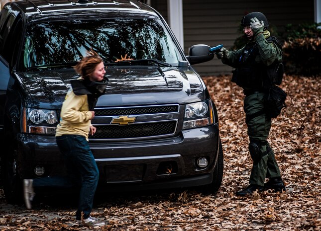 A Charleston County Sheriff’s Office Special Weapons and Tactics member waves a hostage toward him during a training exercise Dec. 6, 2012, at vacant housing on Joint Base Charleston – Air Base, S.C. (U.S. Air Force photo/ Senior Airman Dennis Sloan)