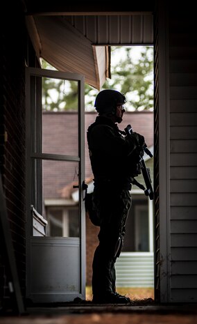 A Charleston County Sheriff’s Office Special Weapons and Tactics member takes cover behind a wall during a hostage extraction training exercise Dec. 6, 2012, at vacant housing on Joint Base Charleston – Air Base, S.C.  The SWAT team provides a coordinated response to critical incidents throughout Charleston County, and whenever requested, in other areas throughout the state of South Carolina. (U.S. Air Force photo/ Senior Airman Dennis Sloan)