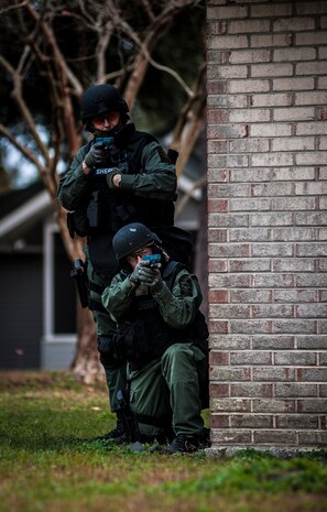 Charleston County Sheriff’s Office Special Weapons and Tactics team aim their training weapons containing simulated rounds at a house during a hostage extraction training exercise Dec. 6, 2012, at vacant housing on Joint Base Charleston – Air Base, S.C. (U.S. Air Force photo/ Senior Airman Dennis Sloan)