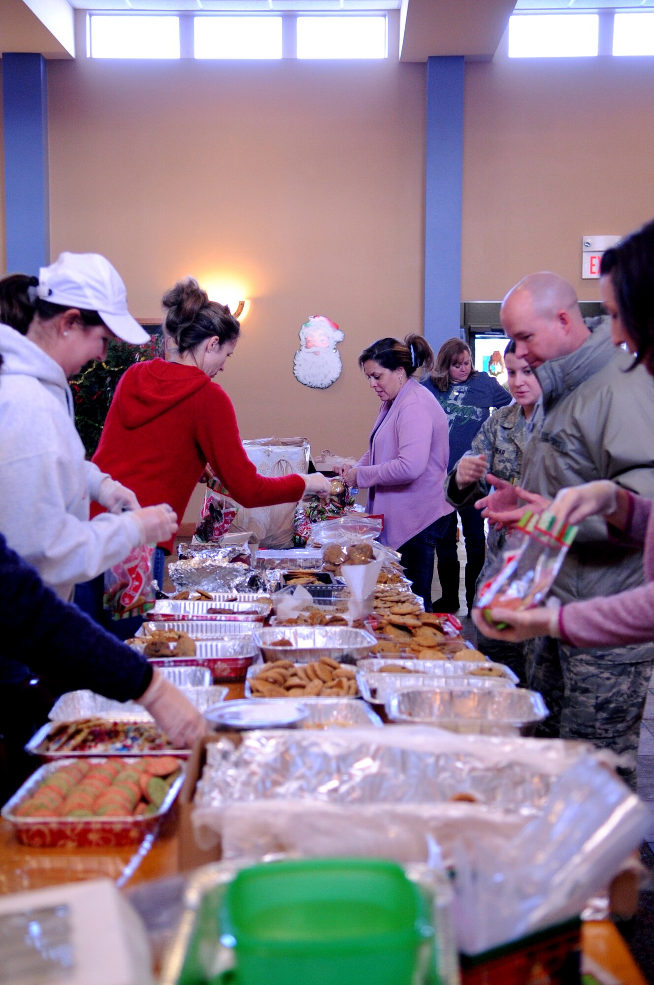 Members from the Grand Forks Air Force Base, N.D., Spouses' Club, prepare cookie bags Dec. 10, 2012, to deliver to Airmen before the holidays. Every year, the Grand Forks AFB Spouses' Club shows their appreciation to Airmen on base by baking cookies and assembling cookie bags to surprise Airmen who live in the dorms on base and Cavalier Air Force Station, N.D. (U.S. Air Force photo/Staff Sgt. Amanda N. Grabiec)