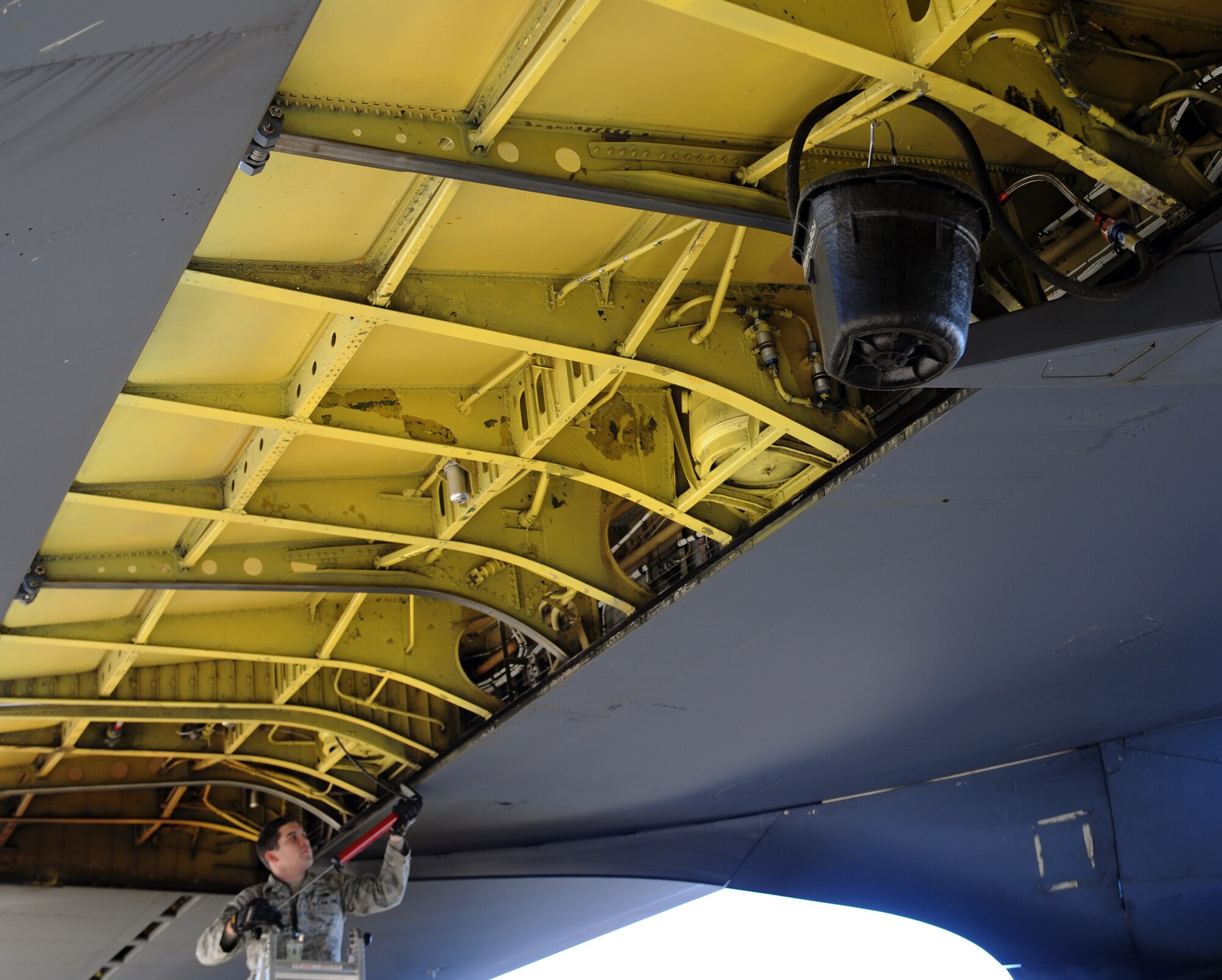 Senior Airman Brandon Marlow, 96th Aircraft Maintenance Unit crew chief, pumps air into the hydraulics reservoir of a B-52H Stratofortress on Barksdale Air Force Base, La., Dec. 12. Air is pumped into the hydraulics reservoir to drain out excess fluid. Not enough pressure inside the hydraulics system may cause the fluid inside to move around, drain out or be distributed unevenly to other systems during flight. (U.S. Air Force photo/Airman 1st Class Benjamin Gonsier)