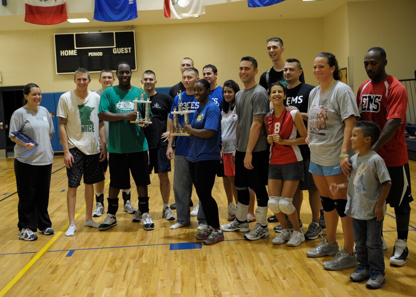 Members of the Intramural Volleyball Championship game gather for a group photo after their tournament in the Freedom I Fitness Center at Moody Air Force Base, Ga., Dec. 6, 2012. The  23d Civil Engineer Squadron faced the 23d Equipment Maintenance Squadron in the final game, where 23d EMS won the championship 15-8. (U.S. Air Force photo by Senior Airman Eileen Meier/Released)