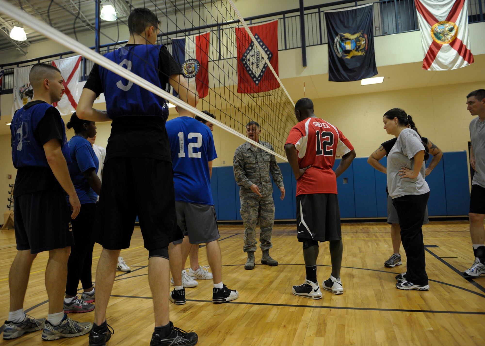 One of the referees for the Intramural Volleyball Championship gathers team members together to reiterate rules of the game in the Freedom I Fitness Center at Moody Air Force Base, Ga., Dec. 6, 2012. The 23d Civil Engineer Squadron matched up against the 23d Equipment Maintenance Squadron, who finished the season with a 16-2 record. 23d EMS eventually won the championship game with a score of 15-8. (U.S. Air Force photo by Senior Airman Eileen Meier/Released) 