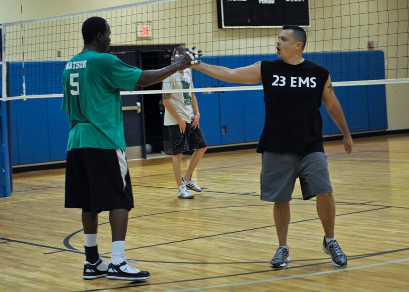 Thomas Watson (left) slaps hands with his teammate Benny Garcia, both from the 23d Equipment Maintenance Squadron, after a play during the Intramural Volleyball Championship in the Freedom I Fitness Center at Moody Air Force Base, Ga., Dec. 6, 2012. The 23d EMS played against the 23d Civil Engineer Squadron, but Watson and Garcia’s 23d EMS team took first. (U.S. Air Force photo by Senior Airman Eileen Meier/Released)