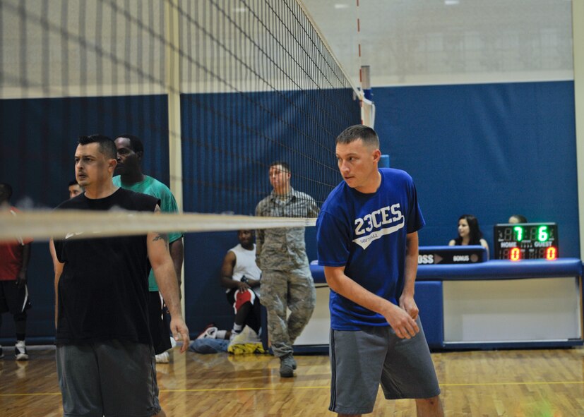 Craig Lancaster, 23d Civil Engineer Squadron setter, looks on at the server during the Intramural Volleyball Championship in the Freedom I Fitness Center  at Moody Air Force Base, Ga., Dec. 6, 2012. The 23d CES played against 23d Equipment Maintenance Squadron Team Two, and even though the 23d EMS took the first place trophy, everyone was smiling and shaking hands after the game. (U.S. Air Force photo by Senior Airman Eileen Meier/Released)