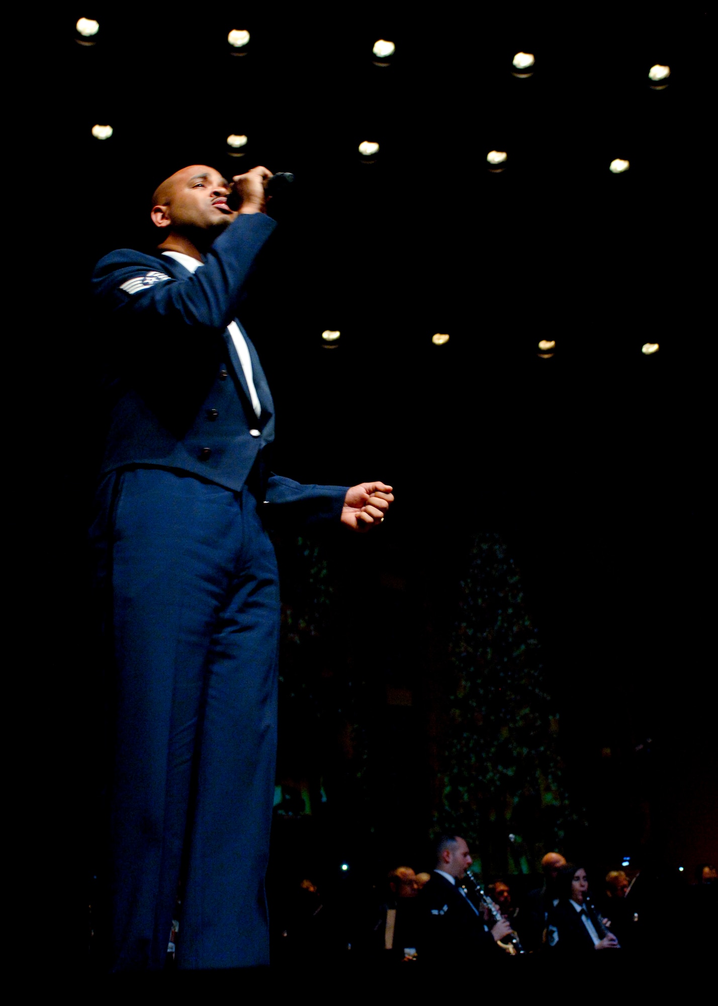 Staff Sgt. Kelcey McDonald, U.S. Air Force Heritage of America Band audio engineer, performs during the band’s holiday concert series Dec. 7, 2012, at Christopher Newport University’s Ferguson Hall , Newport News, Va. McDonald’s musical career started at a young age, when he discovered his singing talent. (U.S. Air Force photo by Airman 1st Class R. Alex Durbin/Released)