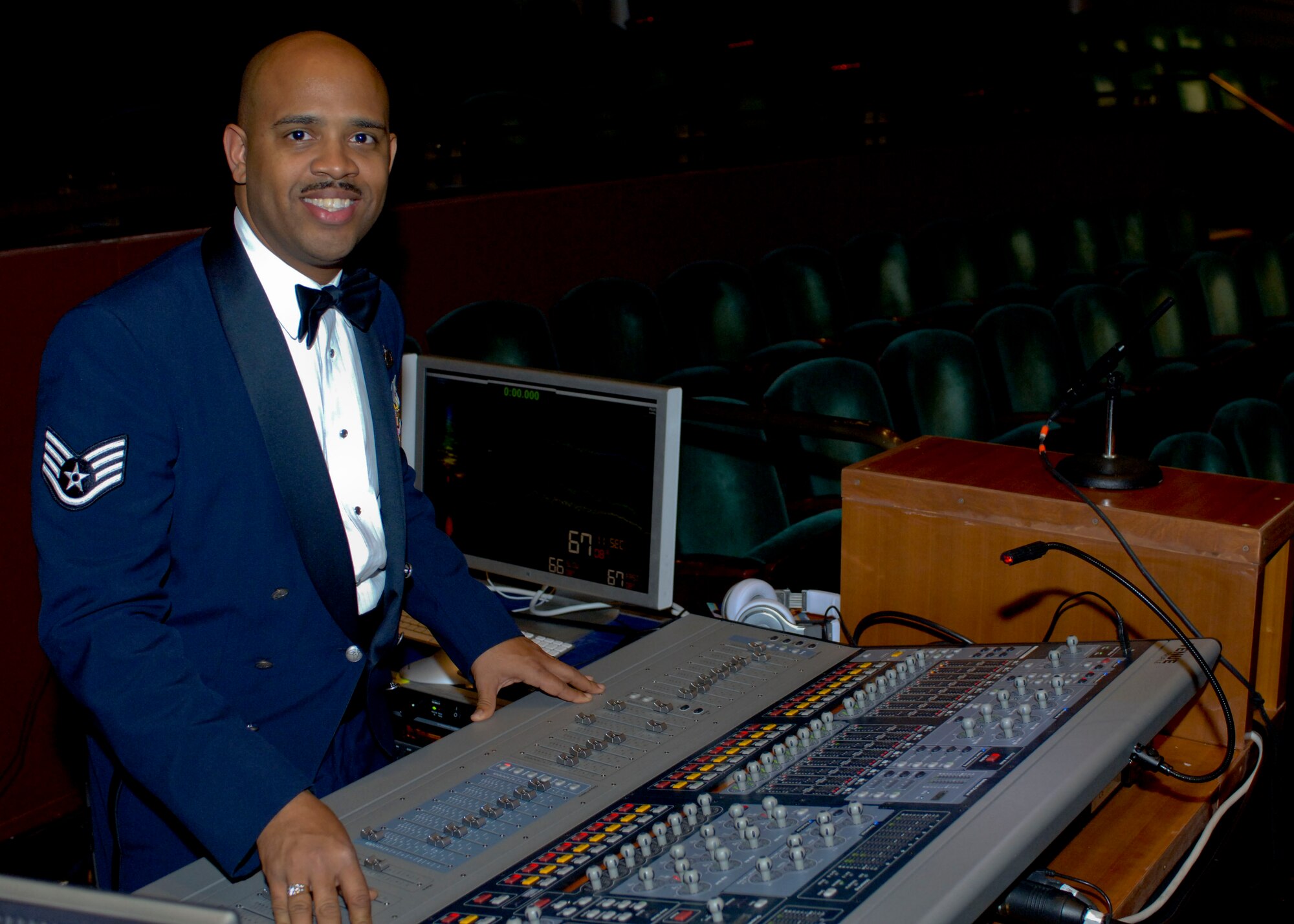 Staff Sgt. Kelcey McDonald, U.S. Air Force Heritage of America Band audio engineer, demonstrates the use of a sound board Dec. 7, 2012, at Christopher Newport University’s Ferguson Hall, Newport News, Va. As the band’s audio engineer, McDonald ensures the listening experience for concert-goers is a pleasant one. (U.S. Air Force photo by Airman 1st Class R. Alex Durbin/Released)